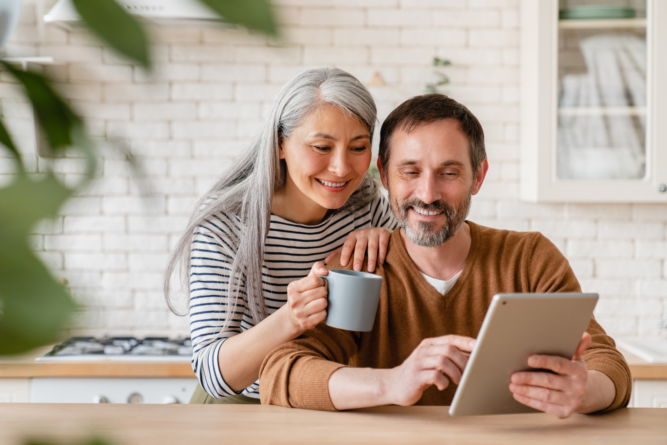 Happy mature couple using a tablet